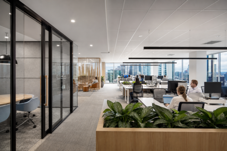 Modern commercial office fitout in a Sydney CBD tower with glass meeting rooms and open plan desks