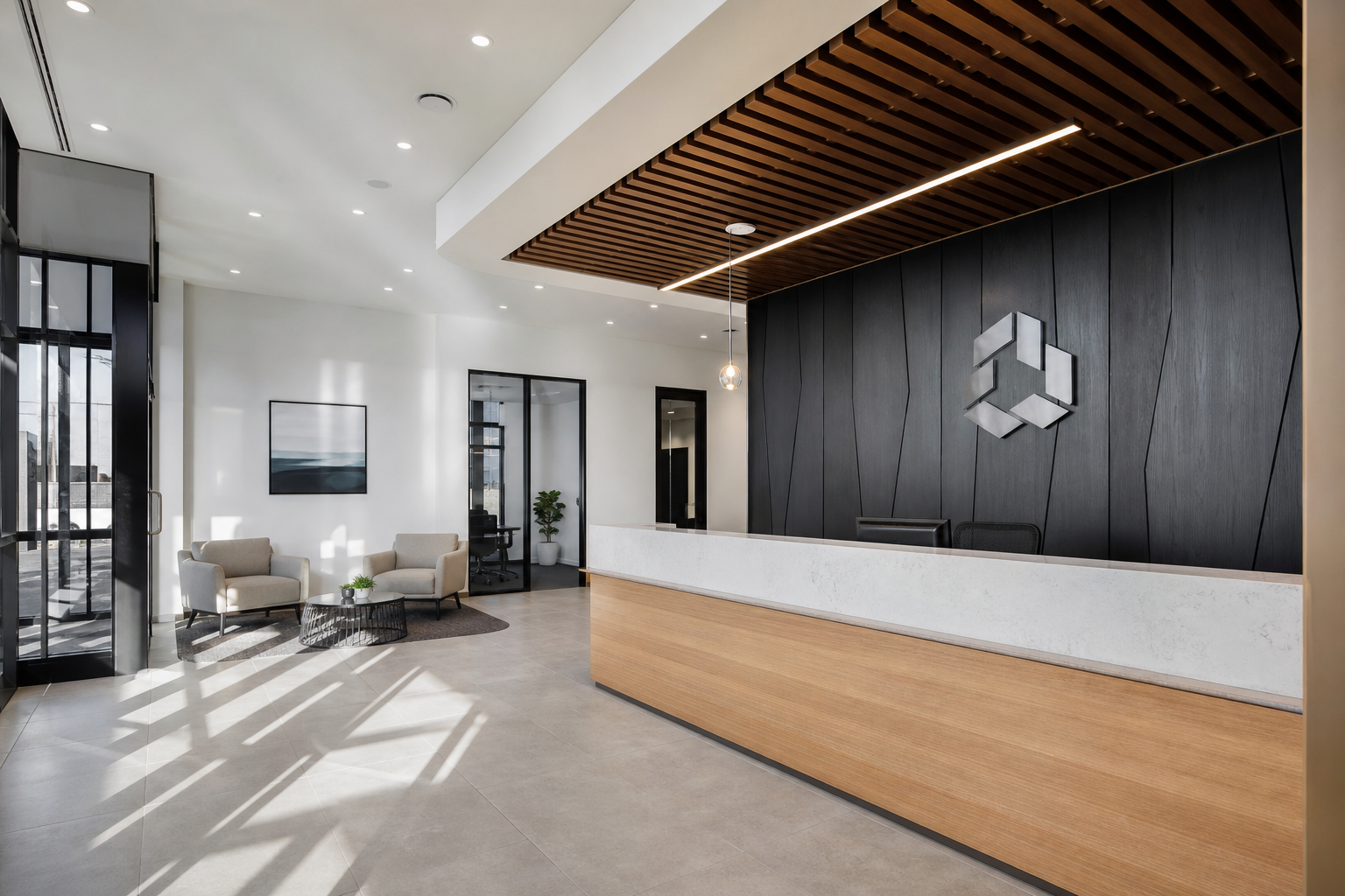 Completed reception area with custom joinery desk and branded signage wall in a Sydney office fitout
