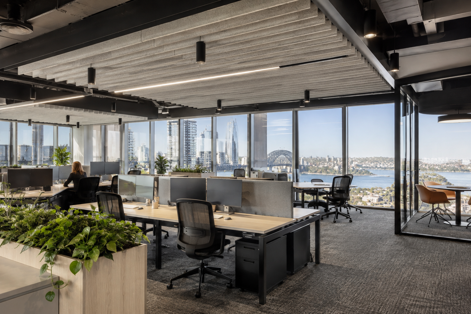 Open-plan office interior design Sydney workstation area with acoustic ceiling treatment and city views